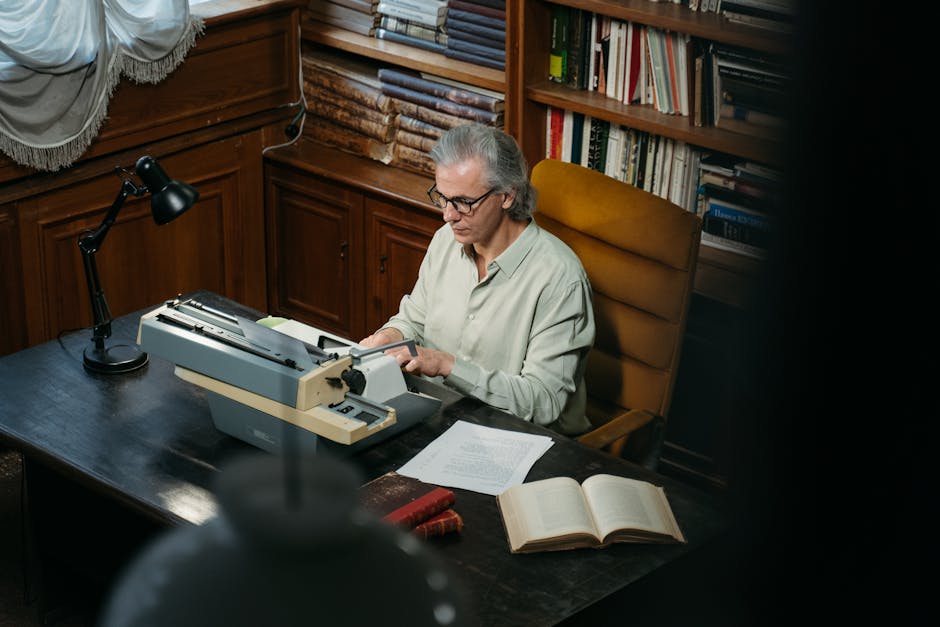 Elderly man with glasses typing on a vintage typewriter in a cozy library.